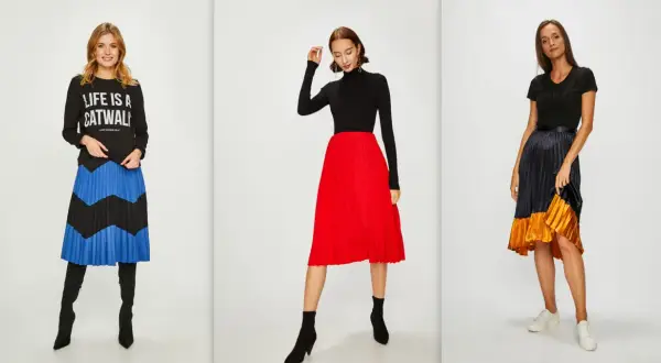 Trzy kobiety prezentują modne stylizacje z plisowanymi spódnicami. Jedna w czarnej bluzie z napisem "LIFE IS A CATWALK" i spódnicy w niebiesko-czarne pasy. Druga w czarnym golfie i czerwonej spódnicy. Trzecia w czarnej bluzce i spódnicy w odcieniach gr...