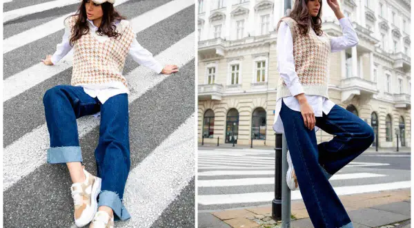 Elegancka stylizacja: jak nosić kamizelkę damską. Modelka w beżowej kamizelce, białej koszuli i jeansach na tle miasta.