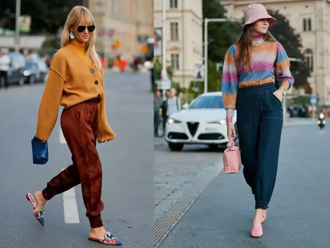 Dwie kobiety prezentują swoje stylizacje dnia, czyli ootd co to. Jedna w musztardowym kardiganie i brązowych spodniach, druga w kolorowym swetrze i granatowych spodniach.